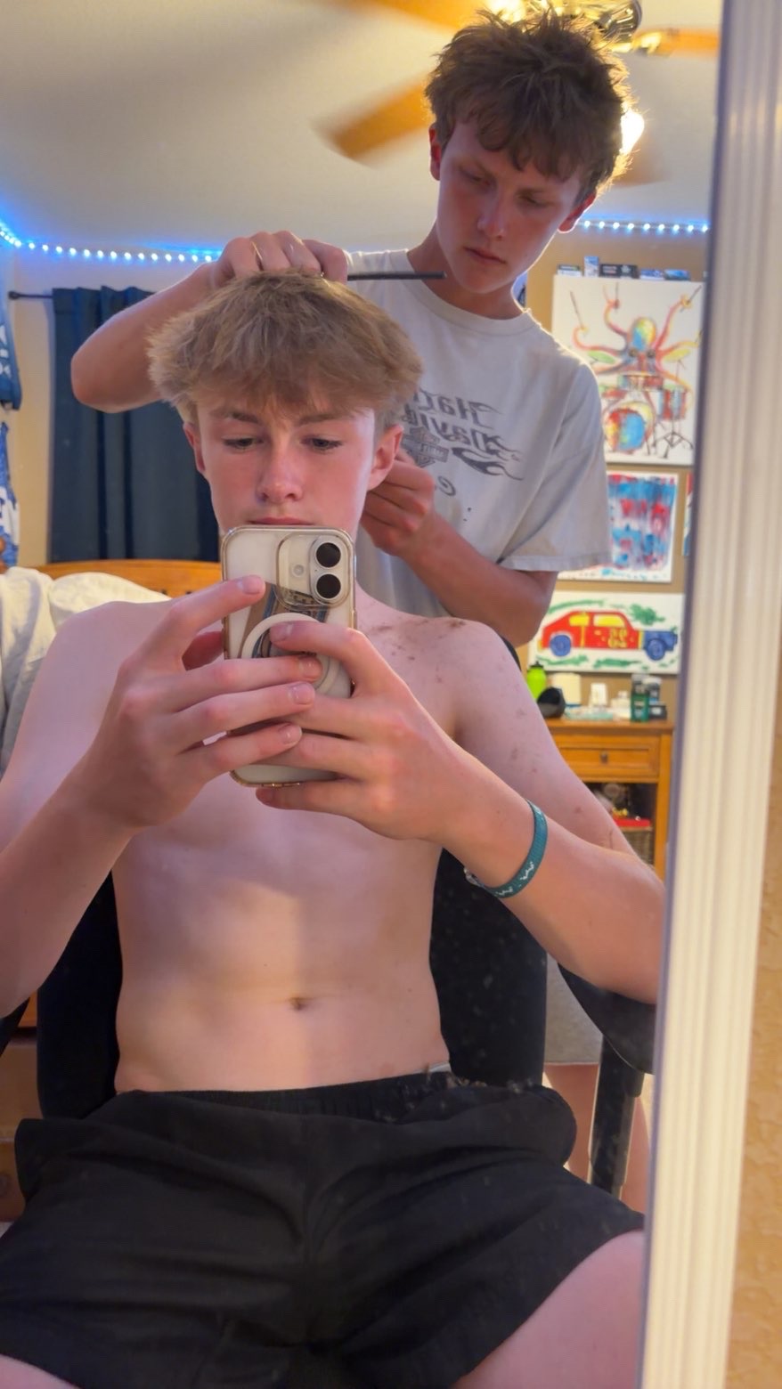 Connor cutting a client's hair at his home setup